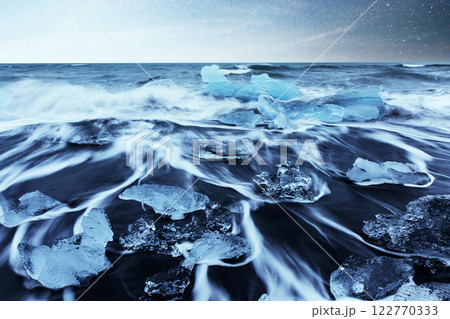 Icebergs floating in Jokulsarlon glacial lake. South Iceland. Lagoon. Starry sky night. Fantastic milky way. 122770333