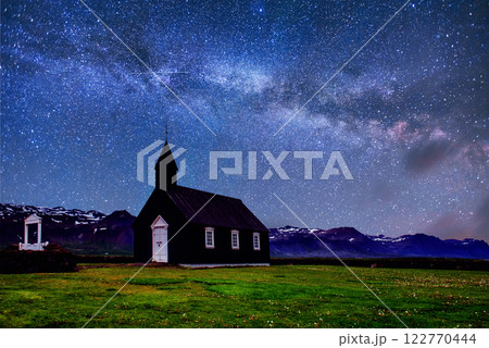 Mountain View Iceland. Fantastic starry sky and the milky way. Beautiful black wooden church in Budir Mountain View Iceland. Fantastic starry sky and the milky way. Beautiful black wooden church in Budir 122770444