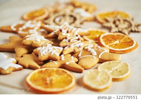 Christmas gingerbread cookies and dried orange and spices on white table Christmas gingerbread cookies and dried orange and spices on white table 122770551