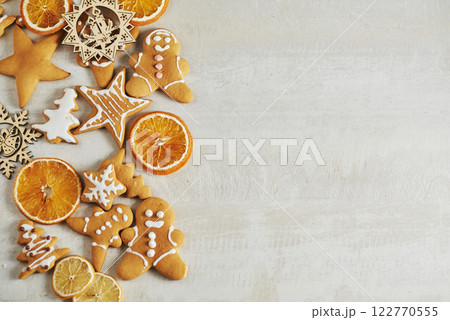 Christmas gingerbread cookies and dried orange and spices on white table Christmas gingerbread cookies and dried orange and spices on white table 122770555