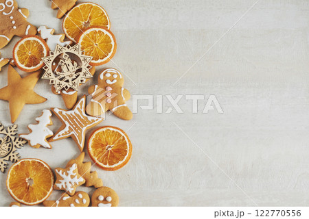 Christmas gingerbread cookies and dried orange and spices on white table 122770556