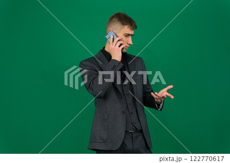 Businessman talking on mobile phone. Male entrepreneur calling someone, having a business call, standing over white background. 122770617