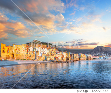 Picturesque evening cityscape of Cefalu city. Popular travel destination of Mediterranean sea. Picturesque evening cityscape of Cefalu city. Popular travel destination of Mediterranean sea. 122771632