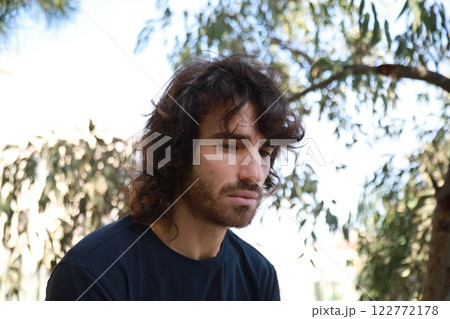 Sad Long Hair Man Is About To Cry From Depression In The Nature Park Sad Long Hair Man Is About To Cry From Depression In The Nature Park 122772178