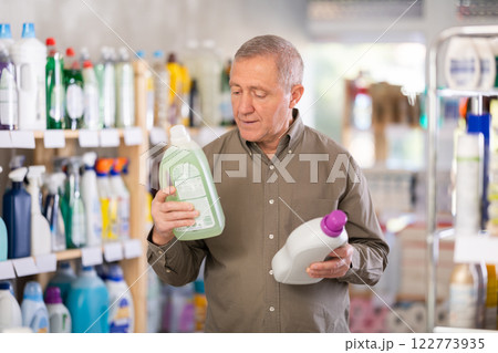 Mature man choosing a cleaning product Mature man choosing a cleaning product 122773935