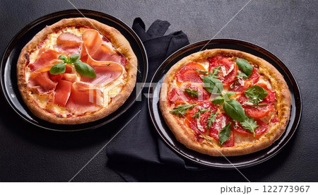 Two Traditional pizza with bresaola, smoked salmon, cheese, tomatoes 122773967