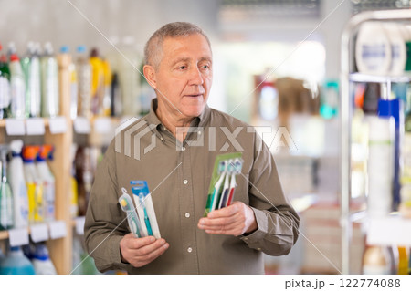man buys toothbrushes man buys toothbrushes 122774088