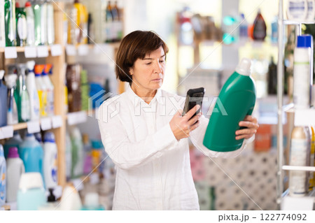 Elderly woman scanning qr code for detergent 122774092