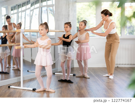 Lesson for little ballerinas - girls learn to dance ballet in choreographic class 122774167