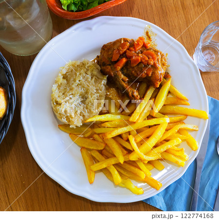 Fried potatoes, sauerkraut, stewed chicken Fried potatoes, sauerkraut, stewed chicken 122774168