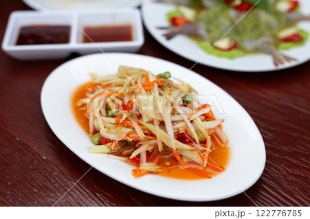 Thai food papaya salad (Som Tum) on a wooden table Thai food papaya salad (Som Tum) on a wooden table 122776785