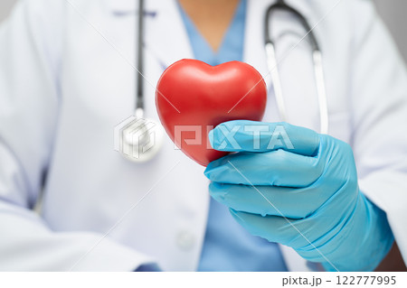Asian woman doctor holding red heart for health in hospital. Asian woman doctor holding red heart for health in hospital. 122777995
