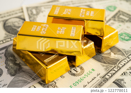 Gold bars with US dollar banknote money, finance trading investment business currency. 122778011