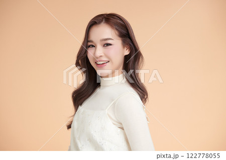 Beautiful young asian woman with clean fresh skin on beige background, Face care, Facial treatment, Cosmetology, beauty and spa, Asian women portrait. Beautiful young asian woman with clean fresh skin on beige background, Face care, Facial treatment, Cosmetology, beauty and spa, Asian women portrait. 122778055
