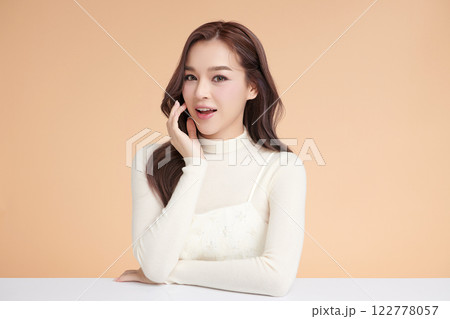 Beautiful young asian woman with clean fresh skin on beige background, Face care, Facial treatment, Cosmetology, beauty and spa, Asian women portrait. 122778057
