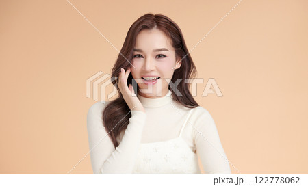 Beautiful young asian woman with clean fresh skin on beige background, Face care, Facial treatment, Cosmetology, beauty and spa, Asian women portrait. 122778062