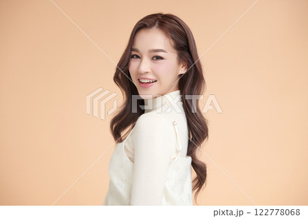 Beautiful young asian woman with clean fresh skin on beige background, Face care, Facial treatment, Cosmetology, beauty and spa, Asian women portrait. 122778068