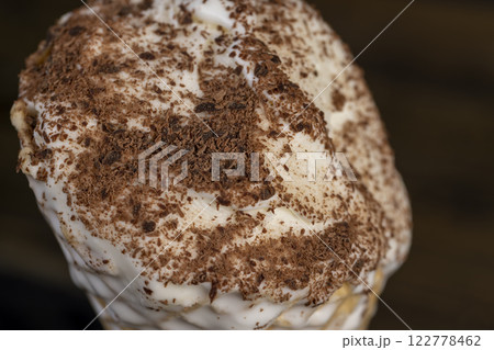 sweet melting white ice cream with chocolate chips in a waffle cone sweet melting white ice cream with chocolate chips in a waffle cone 122778462