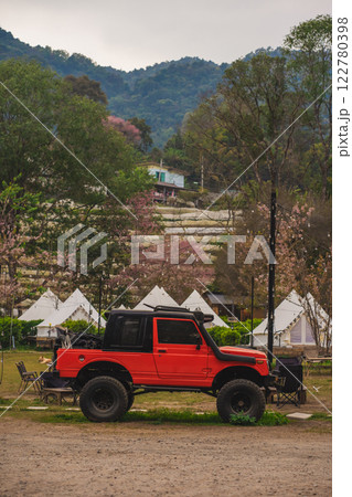 travel in nature concept with pink cherry blossom tree and camping tent in springtime season 122780398