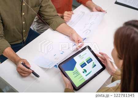 asian financial advisor presenting charts and data on a tablet during couple client meeting.financial planning and decision-making 122781345