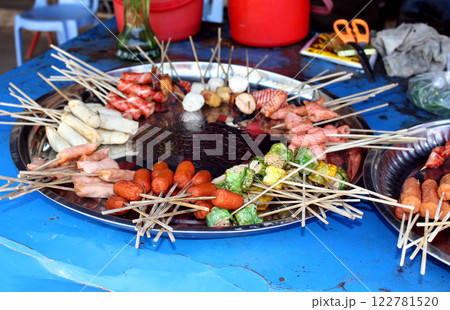 Traditional asian street food, Myanmar (Burma), Southeast Asia. Fresh snack food on Stick on street fish market 122781520