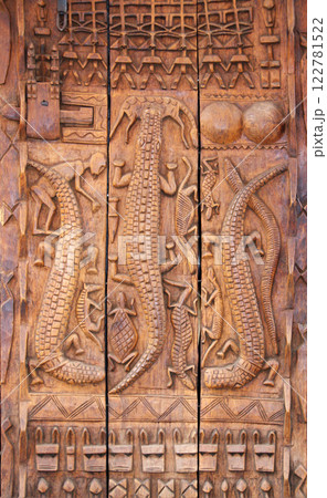 Traditional moroccan wood carving shutter with animals like crocodiles, turtle, antelope. Street shop of traveller souvenirs in medina of Marrakech, Morocco. Tourist wooden souvenir on market street Traditional moroccan wood carving shutter with animals like crocodiles, turtle, antelope. Street shop of traveller souvenirs in medina of Marrakech, Morocco. Tourist wooden souvenir on market street 122781522