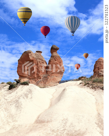 The balloon flight, famous tourist attraction of Cappadocia. Air balloons and Camel rock at Devrent valley (Imaginary valley), Cappadocia, Anatolia, Turkey 122781523