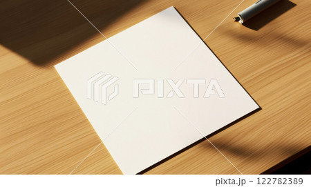 clean piece of note paper on wooden desk with pen nearby 122782389