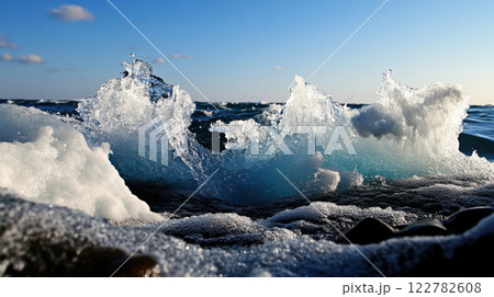 Cresting waves crashing against rocks create stunning ocean scene Cresting waves crashing against rocks create stunning ocean scene 122782608