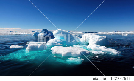 Majestic icebergs floating in clear blue water under bright sky 122782611
