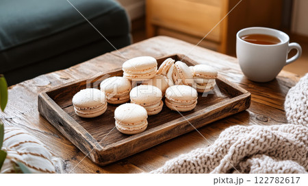 casual arrangement of macarons on rustic wooden tray with tea casual arrangement of macarons on rustic wooden tray with tea 122782617