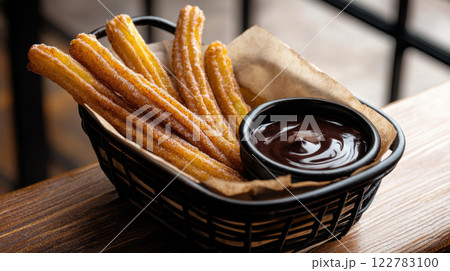 Crispy churros with cinnamon sugar served with chocolate sauce Crispy churros with cinnamon sugar served with chocolate sauce 122783100