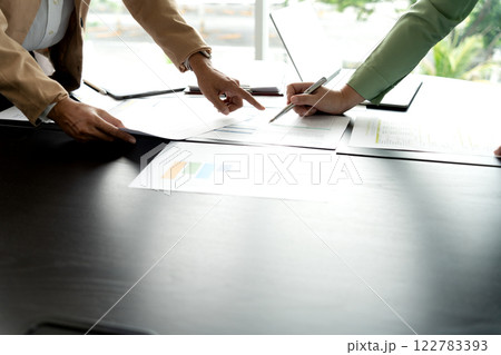 In Marketing brainstrom meeting The team is standing and pointing In Marketing brainstrom meeting The team is standing and pointing 122783393