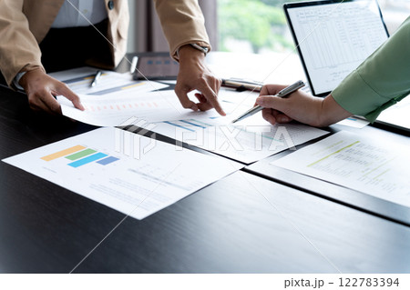 In Marketing brainstrom meeting The team is standing and pointing In Marketing brainstrom meeting The team is standing and pointing 122783394