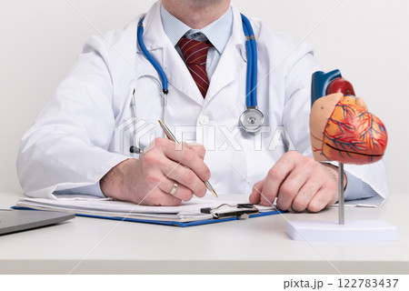 Anatomical model human heart on work desk of doctor in medical clinic. 122783437