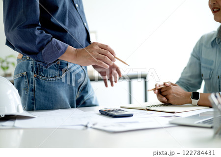 Architect or engineer are discussing and consulting in the office 122784431