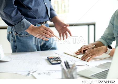 Architect or engineer are discussing and consulting in the office 122784432