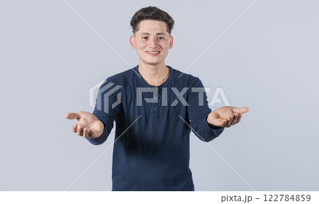 Generous man with open arms, Man sharing open hands looking at the camera with a friendly smile, Man welcoming head-on 122784859