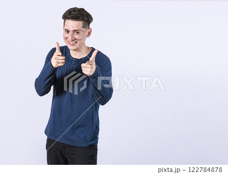 young man with thumbs up on white background, positive boy with thumbs up doing ok, Smiling man showing ok gesture looking at camera young man with thumbs up on white background, positive boy with thumbs up doing ok, Smiling man showing ok gesture looking at camera 122784878