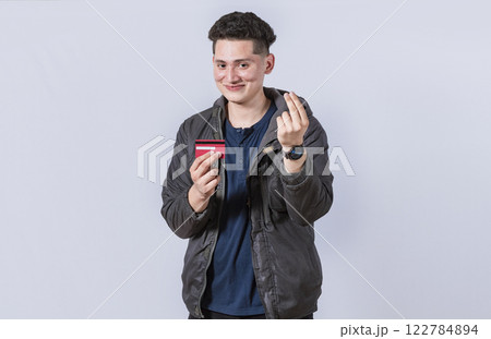 Handsome man holding credit card, A guy holding credit card smiling, electronic payment concept Handsome man holding credit card, A guy holding credit card smiling, electronic payment concept 122784894