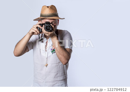 tourist in a hat with a camera, Happy tourist in a hat with a camera around his neck 122784912