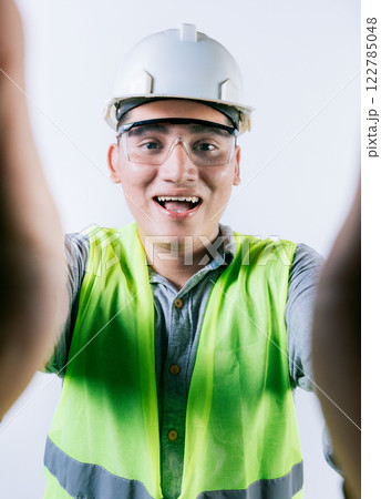 Cheerful builder engineer taking a selfie isolated. Engineer taking a selfie isolated. Smiling male engineer taking a selfie looking at camera 122785048