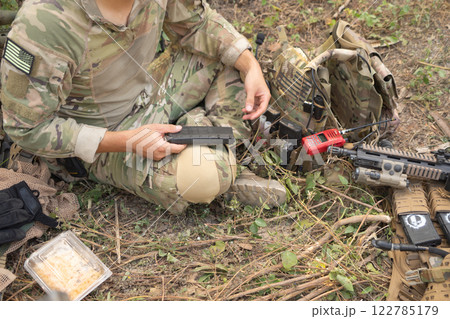 Team of U.S. Army marine corps soldier military war with gun weapon participating and preparing to attack the enemy in Thailand during exercise Cobra Gold training in battle. Combat force. Team of U.S. Army marine corps soldier military war with gun weapon participating and preparing to attack the enemy in Thailand during exercise Cobra Gold training in battle. Combat force. 122785179