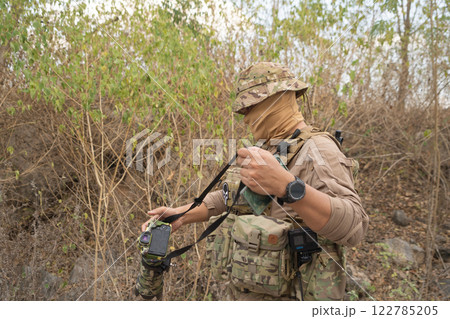 Team of U.S. Army marine corps soldier military war with gun weapon participating and preparing to attack the enemy in Thailand during exercise Cobra Gold training in battle. Combat force. Team of U.S. Army marine corps soldier military war with gun weapon participating and preparing to attack the enemy in Thailand during exercise Cobra Gold training in battle. Combat force. 122785205