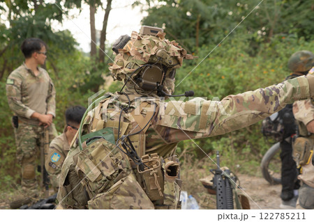 Team of U.S. Army marine corps soldier military war with gun weapon participating and preparing to attack the enemy in Thailand during exercise Cobra Gold training in battle. Combat force. 122785211