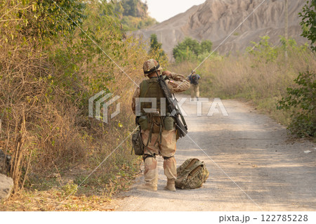 Team of U.S. Army marine corps soldier military war with gun weapon participating and preparing to attack the enemy in Thailand during exercise Cobra Gold training in battle. Combat force. Team of U.S. Army marine corps soldier military war with gun weapon participating and preparing to attack the enemy in Thailand during exercise Cobra Gold training in battle. Combat force. 122785228