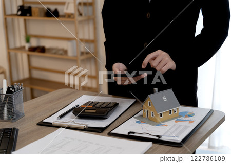 real estate agent woman is preparing documents and information 122786109