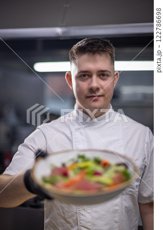 Chef holding gourmet salad 122786698