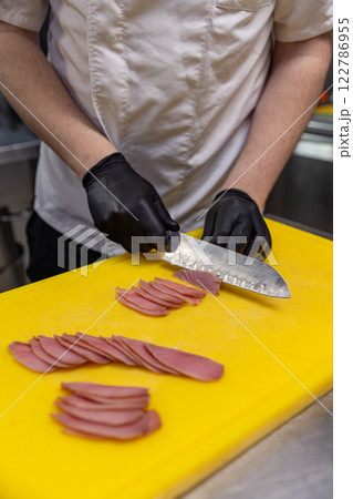 Professional chef slicing tuna 122786955