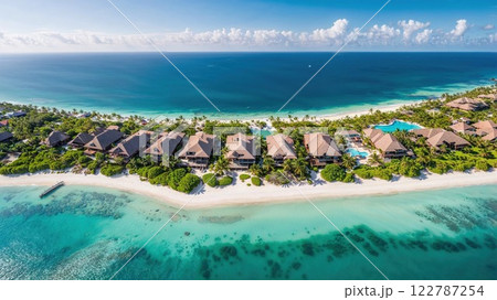 Aerial view of luxurious beachfront villas surrounded by turquoise waters, lush greenery, and pristine white sand, capturing the ultimate tropical paradise 122787254